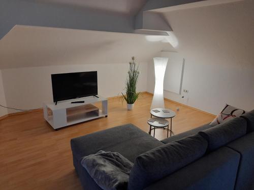 a living room with a couch and a flat screen tv at Casa Tina in Homberg