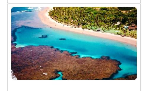 an aerial view of a beach with blue water at Taipu - BEM PERTO das Piscinas Naturais in Marau
