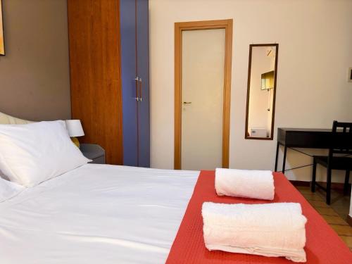 a bedroom with a bed with two towels on it at Poseidon Bay Residence in Milazzo