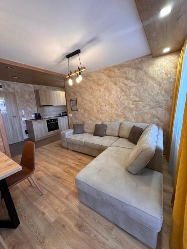 a living room with a couch and a table at Alpine luxury two bed-two bathrooms apartment B25 in Borovets