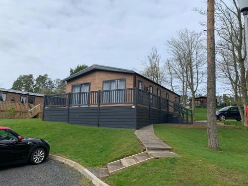 a house with a car parked in front of it at 30 Golf View in Jedburgh