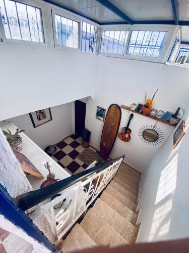 a room with a staircase with a surfboard on the wall at Cozy Beach Camp in Agadir