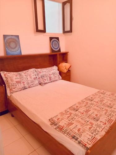 a bedroom with a bed with a wooden head board at Cozy Beach Camp in Agadir