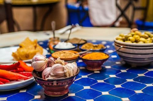 a blue and white table topped with bowls of food at Cozy Beach Camp in Agadir