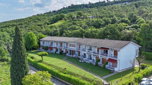 an aerial view of a large house on a hill at Garda Panoramic House in Albisano