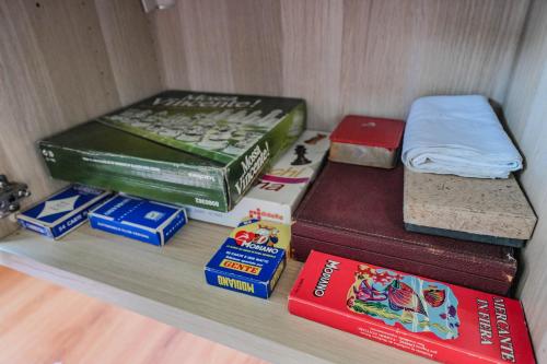a shelf with books and other items on it at Garda Panoramic House in Albisano