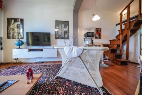 a living room with a stool and a television at Garda Panoramic House in Albisano