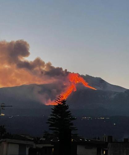 a fire is burning in front of a mountain at Panoramic Etna in Stazzo