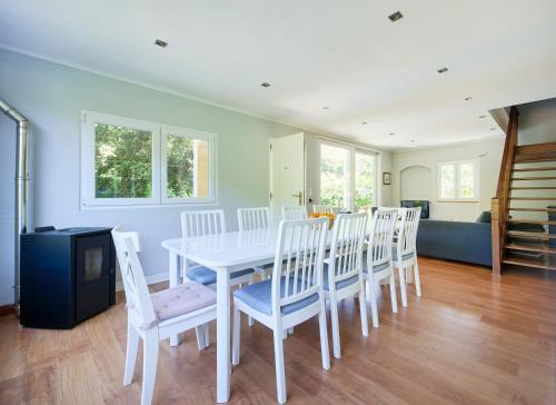 a dining room with a white table and chairs at Beach & Nature Villa with Amazing Pool by TimeCooler in Setúbal