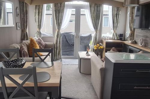 a living room with a couch and a table at Deluxe 3 Bed Holiday Home in Port Seton in Port Seton