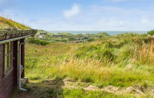 an old house on a hill with the ocean in the background at 2 Bedroom Lovely Home In Saltum in Saltum