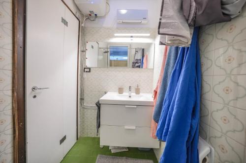 a small bathroom with a sink and a mirror at Garda Panoramic House in Albisano