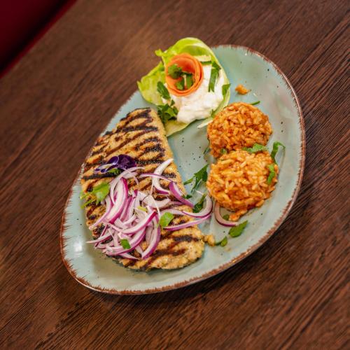 a plate of food with a sandwich on a table at Hotel & Restaurant Sparta in Oldenburg