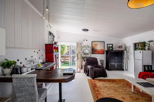 a kitchen and living room with a table and a dining room at Studio47 in Despatch