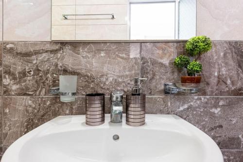 a white sink in a bathroom with some plants at Potam'Sea Bliss 4 - Beach Front, Sun Beds & Parking in Himare