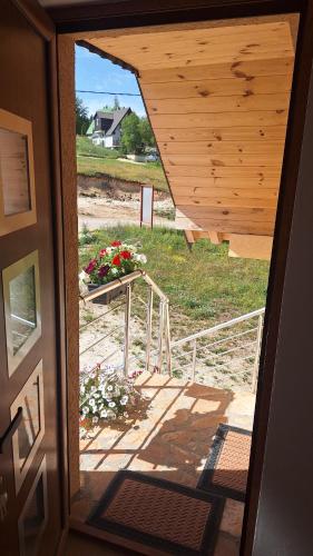 a view of a porch with a table with flowers at Apartments Orchidea in Žabljak