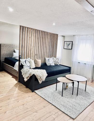a bedroom with a blue bed and a table at 1 - 4 Pers Apartment Jeßnitz, Mawoi Living in Jeßnitz