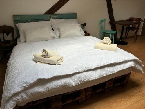 a bedroom with a bed with towels on it at Povala s parkovaním staré mesto in Žilina