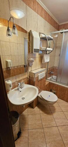 a bathroom with a sink and a toilet at SOBE/ROOMS RIVA in Zadar