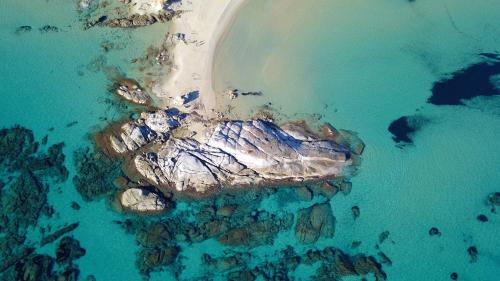 an aerial view of an island in the water at S'Arrioleddu in Muravera