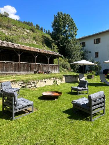 a group of chairs and a table in a yard at Exclusive Apartment Tassenbacherhof in Strassen