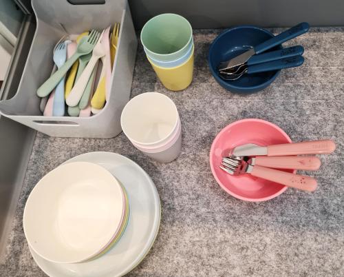 a table with plates and cups and utensils at Herz-Oase in Eigeltingen
