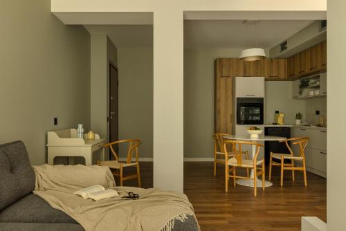 a living room and kitchen with a couch and a table at The Offset in Ioannina