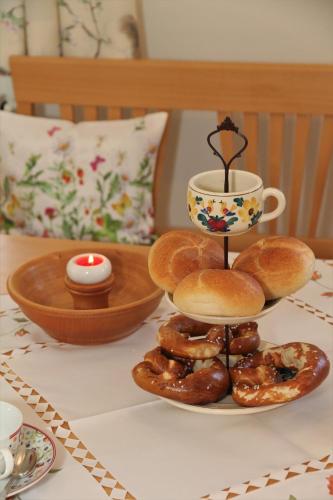 a plate of donuts and a cup of coffee on a table at Bocksleitnerhof in Wackersberg