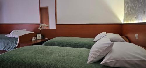 a hotel room with two beds in a room at SOBE/ROOMS RIVA in Zadar