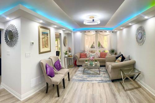 a living room with a couch and chairs at Super Luxury Family Home - 3 Bedrooms, 1 Full Bathroom and 1 Half Washroom with Free Parking, Wifi, Netflix in Toronto