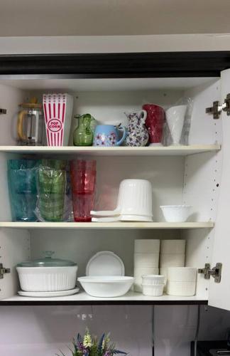 a shelf filled with plates and bowls and dishes at Super Luxury Family Home - 3 Bedrooms, 1 Full Bathroom and 1 Half Washroom with Free Parking, Wifi, Netflix in Toronto