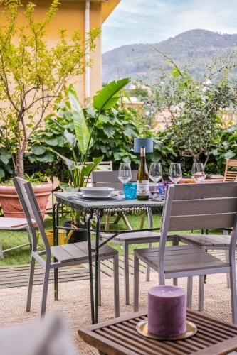 a table and chairs with wine glasses on a patio at TERRAZZA PORTOFINO Splendido appartamento con piscina idromassaggio - PARCHEGGIO GRATIS in Santa Margherita Ligure