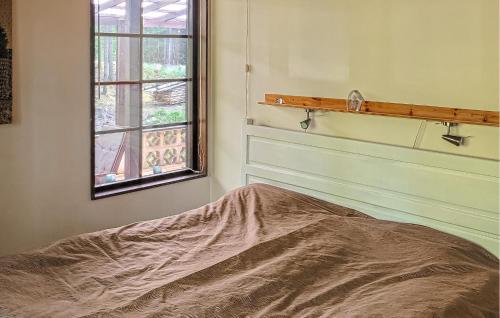 a bedroom with a bed and a window at Holiday Home Putsered Knäred in Putsered
