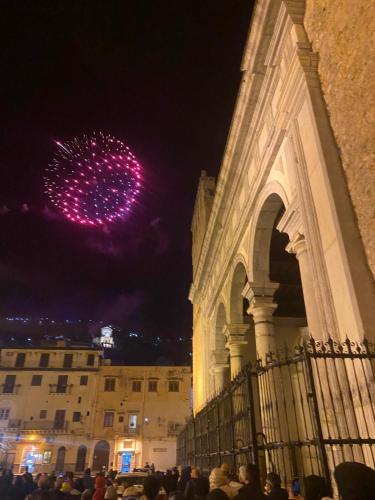 a crowd of people standing in front of a building with a firework at Teresita in Monreale
