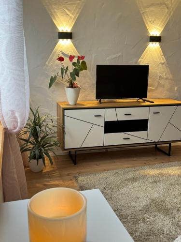 a living room with a tv on a dresser at Apartment Balingen City in Balingen