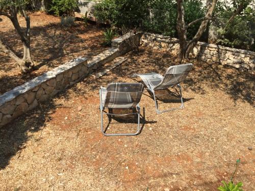 two chairs and a table in a yard at Holiday Home Anja in Supetar