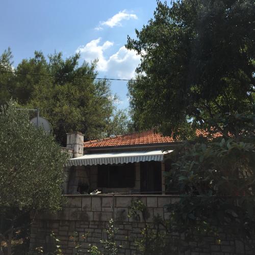a house with a window and a brick wall at Holiday Home Anja in Supetar