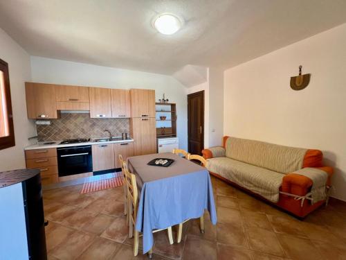 a living room with a table and a couch at Villa Sunrise in Budoni