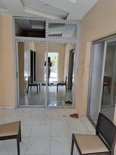 a woman taking a picture of a mirror in a room at darou salam house in Rufisque