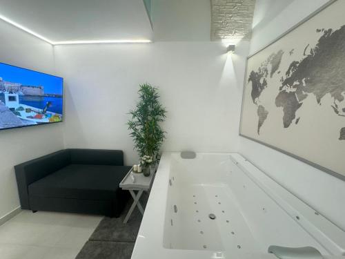a living room with a couch and a world map on the wall at Acqua e Sale in Gallipoli