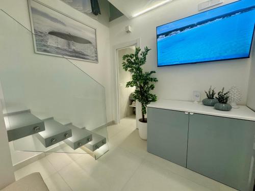a living room with a flat screen tv on a wall at Acqua e Sale in Gallipoli