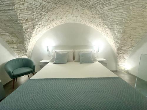 a bedroom with a large bed with a stone ceiling at Acqua e Sale in Gallipoli