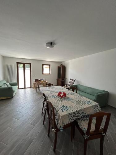 a living room with a table and a couch at Affittacamere "Fratello Sole e Sorella Luna" in Greccio