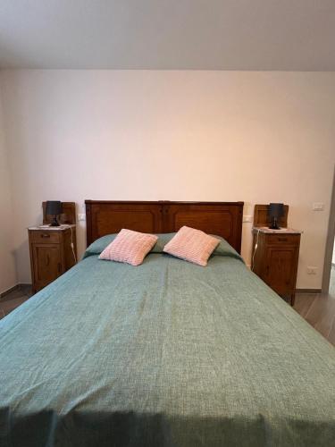 a bedroom with a bed with two pillows on it at Affittacamere "Fratello Sole e Sorella Luna" in Greccio