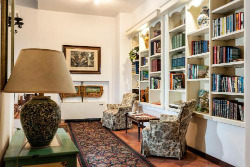 a living room with two chairs and a lamp on a table at Hotel Sirius in Taormina