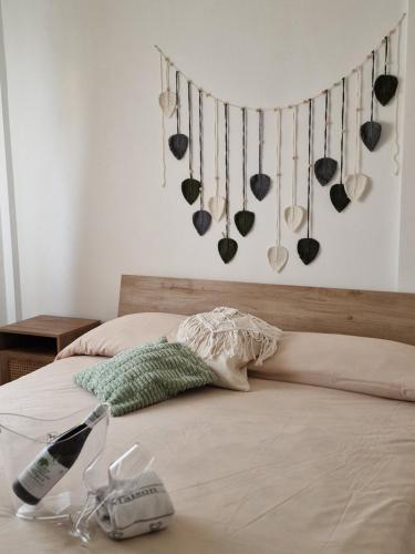 a bedroom with a bed with utensils hanging on the wall at Cerry's Apartments Fronte Mare - Seaside & Sealight in Fossacesia