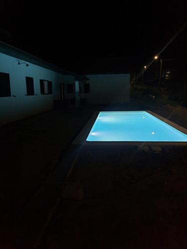 a swimming pool in the dark at night at Pousadinha de Paradela in Paradela