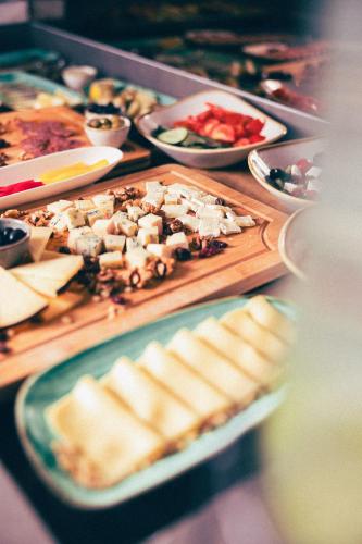 a table with plates of food on a table at Hotel Fanat in Split
