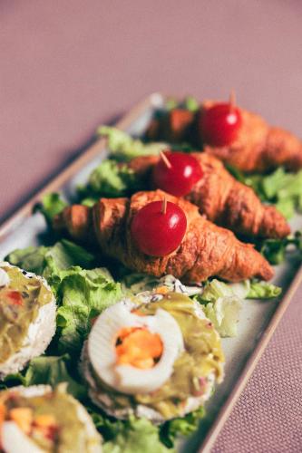 a plate of food with an egg and vegetables at Hotel Fanat in Split