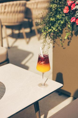 a drink in a glass sitting on a table at Hotel Fanat in Split